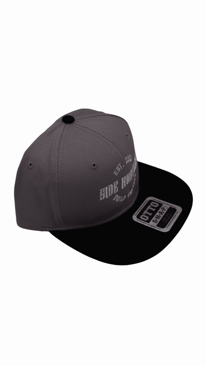 Premium Otto snapback hat with dark grey and black brim with side hustle embroidered design on front